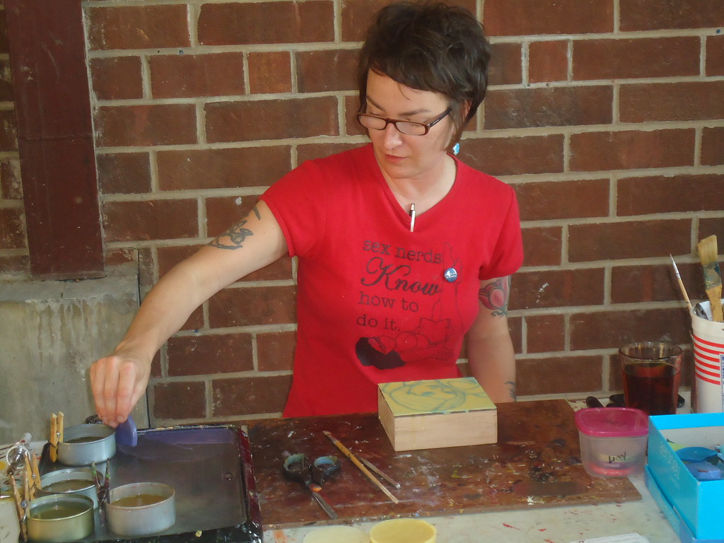 Libby Lynn demonstrates encaustic wax art for the art show
